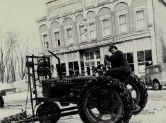 Vermontville Main Street. Gordon Lovell 1941 Farmall H. Farmers Friend, belt driven, mechanical lift loader - Winter 1941. Lovell Implement 